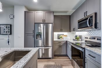 42” Upper cabinets with tile backsplash and under cabinet lighting